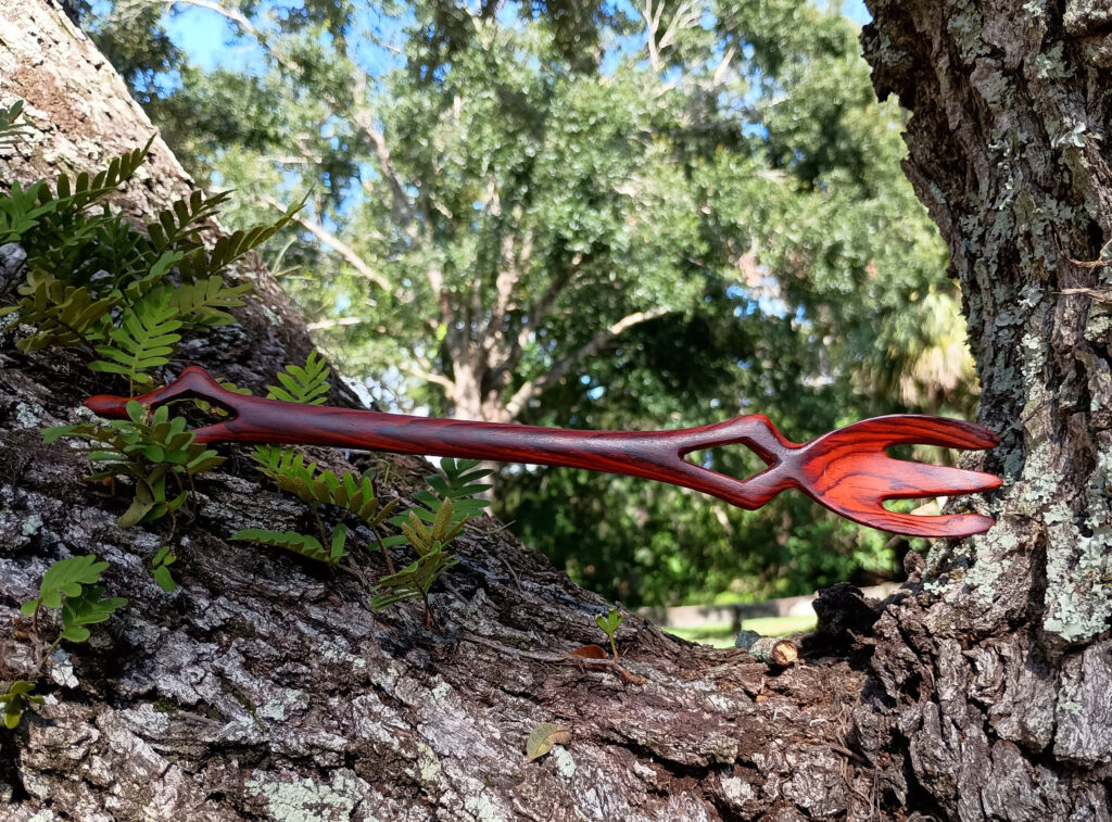 Handmade cocobolo fork (horizontal view) with carved handle orifices. July 2025